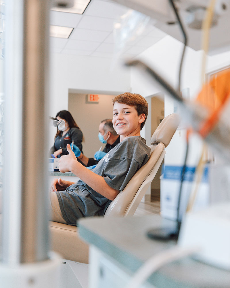 Child gives a thumbs-up after finding a new general dentist